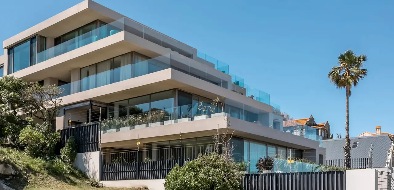 Modern apartment building with tiered levels and glass balconies