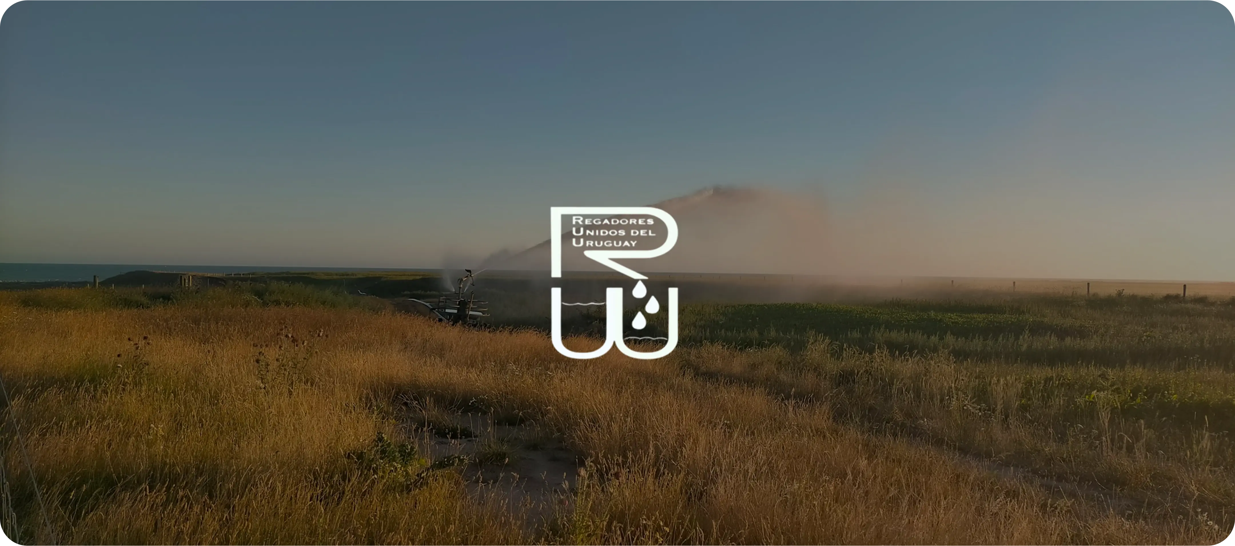 Regadores Unidos del Uruguay logo over field irrigation system background.