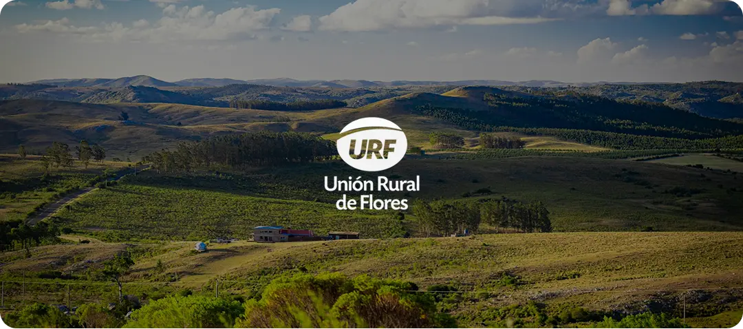 Rolling hills landscape featuring URF - Unión Rural de Flores logo